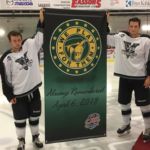 Sept 21, 2018 - Zach Falck (left) and Donavon Beatty hold the "We Play For Them" banner at the Kings Mutual Century Centre in honour of the Humboldt Broncos. The players were chosen as Falck is from Winnipeg and Beatty hails from Regina.